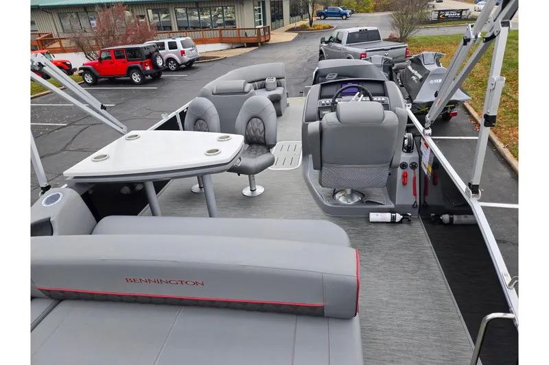 Slide: The Image of 2022 Bennington LX 24 Swingback pontoon boat interior with seating and control console. - 20