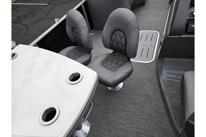 Slide: The Image of 2022 Bennington LX 24 Swingback interior with gray seating and table. - 21