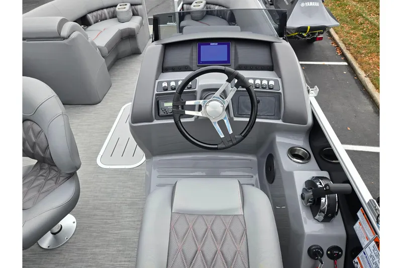 Slide: The Image of 2022 Bennington LX 24 Swingback boat interior with steering wheel and seating. - 22