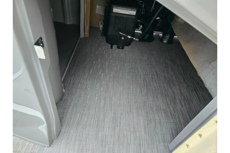 Slide: The Image of Interior view of 2022 Bennington LX 24 Swingback boat storage compartment. - 24