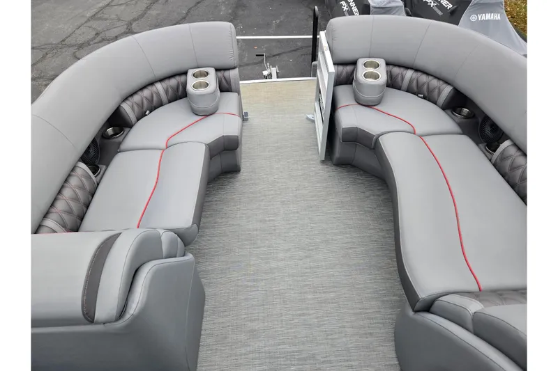 Slide: The Image of 2022 Bennington LX 24 Swingback interior with gray seating and red accents. - 25