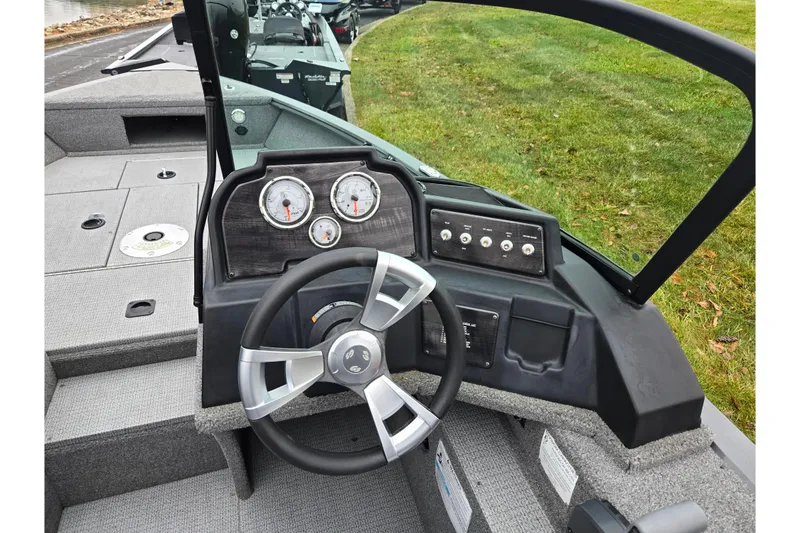 Slide: The Image of 2022 G3 Angler V164 F boat dashboard with steering wheel and gauges. - 11