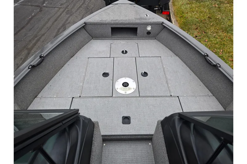 Slide: The Image of 2022 G3 Angler V164 F boat interior with gray carpeted deck and storage compartments. - 13