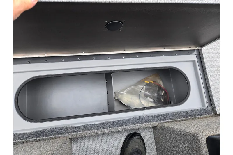 Slide: The Image of Open storage compartment in 2022 G3 Angler V164 F boat, showing interior space. - 14
