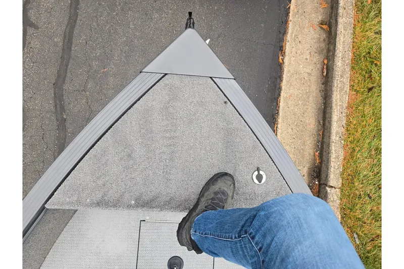 Slide: The Image of Person standing on 2022 G3 Angler V164 F boat, showing deck and shoe. - 16