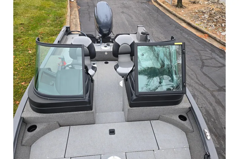 Slide: The Image of 2022 G3 Angler V164 F boat with dual windshields and seating, parked on pavement. - 18