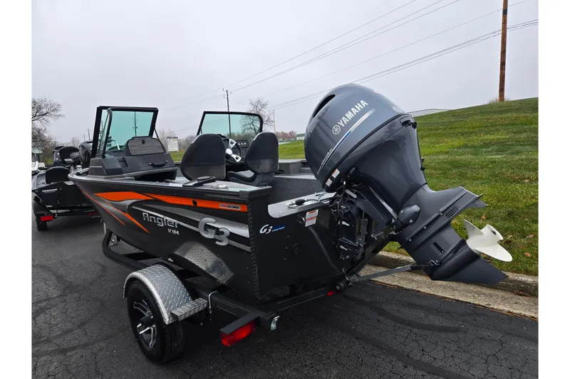 Slide: The Image of 2022 G3 Angler V164 F boat with Yamaha motor on a trailer, parked outdoors. - 3