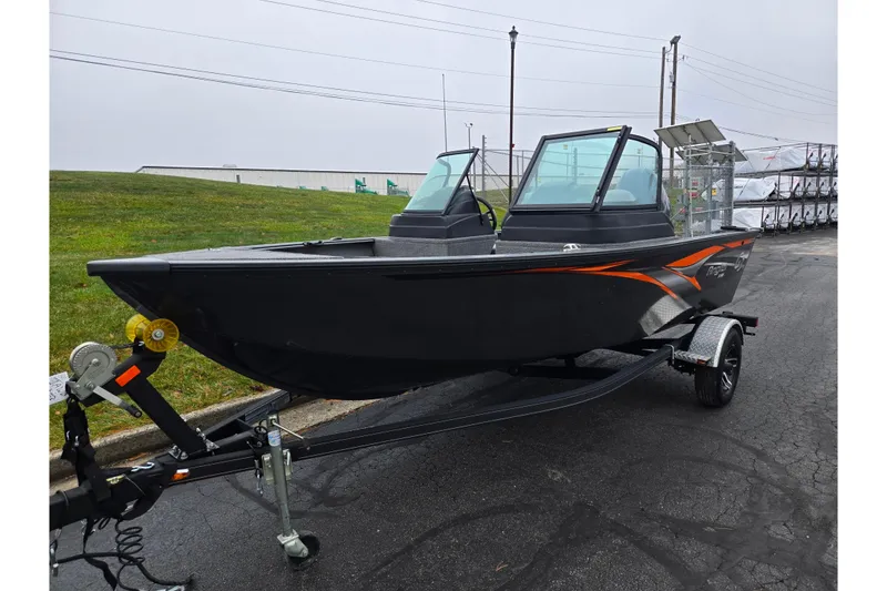 Slide: The Image of 2022 G3 Angler V164 F fishing boat on trailer, black with orange accents. - 5
