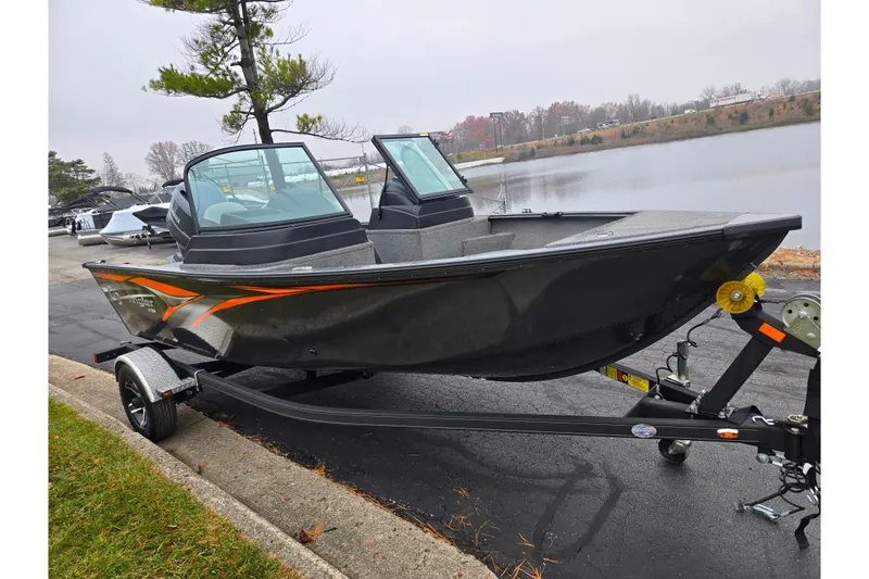 Slide: The Image of 2022 G3 Angler V164 F fishing boat on trailer by a lake. - 8