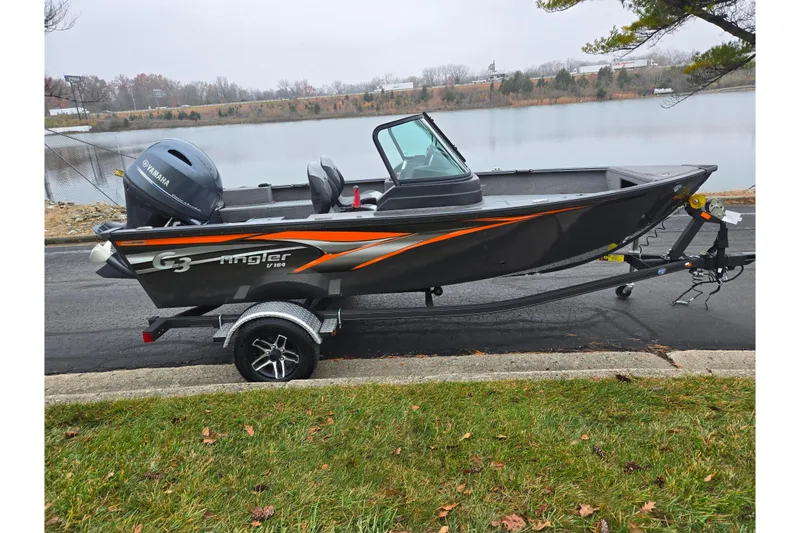 Slide: The Image of 2022 G3 Angler V164 F boat with Yamaha motor on trailer by a lake. - 9