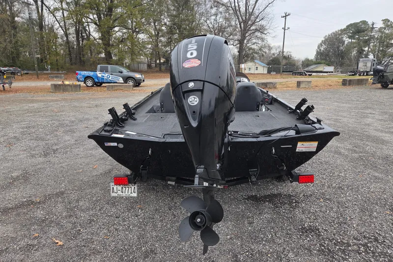 Slide: The Image of 2018 Lowe Stinger 195C boat with outboard motor in a parking area. - 4