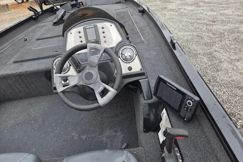 Slide: The Image of 2018 Lowe Stinger 195C boat interior with steering wheel and control panel. - 8