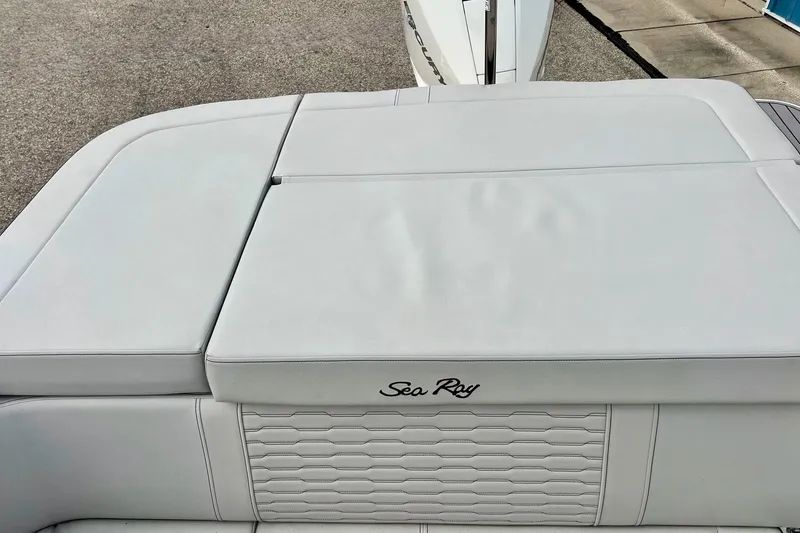 Slide: The Image of 2023 Searay SPX230 boat with sleek white upholstery and Sea Ray logo. - 14
