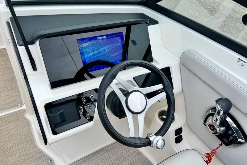 Slide: The Image of 2023 Searay SPX230 boat dashboard with steering wheel and control panel. - 40