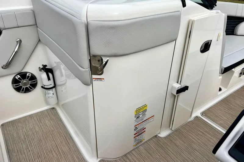 Slide: The Image of 2023 Searay SPX230 boat interior with safety equipment and seating area. - 44
