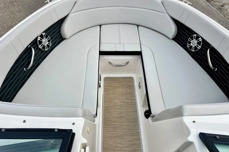 Slide: The Image of 2023 Searay SPX230 boat interior with cushioned seating and stainless steel accents. - 48
