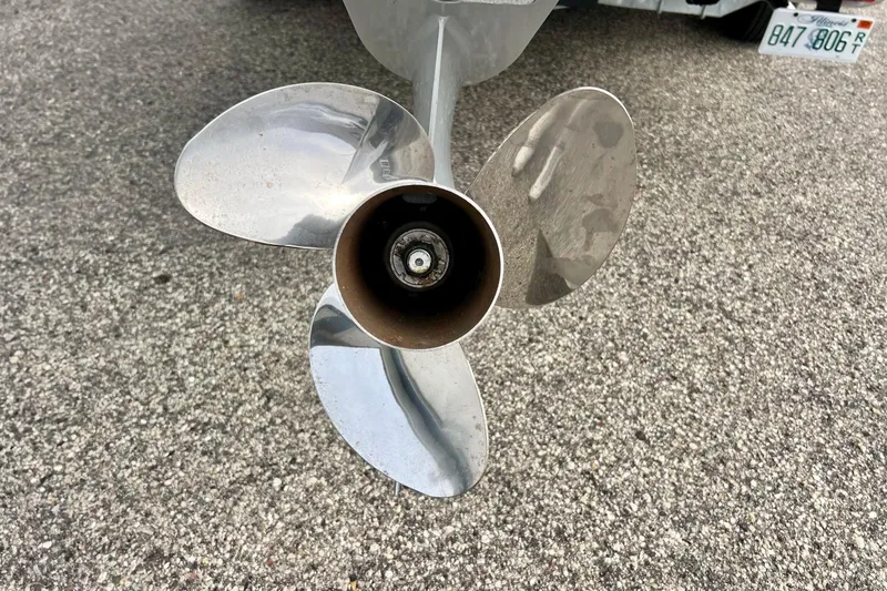 Slide: The Image of 2023 Searay SPX230 boat propeller on asphalt surface, close-up view. - 8