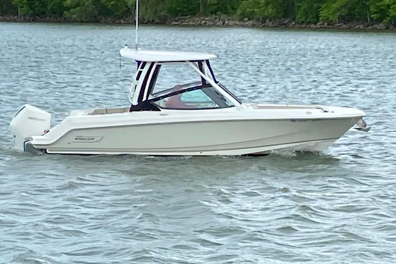 The Image of 2022 Boston Whaler 240 Vantage boat cruising on a lake. - 0