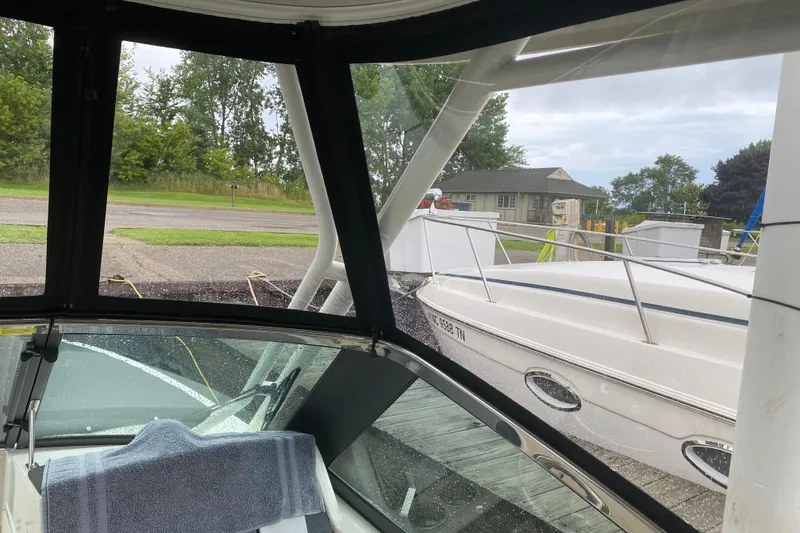 Slide: The Image of 2022 Boston Whaler 240 Vantage boat docked, view from inside with overcast sky. - 8