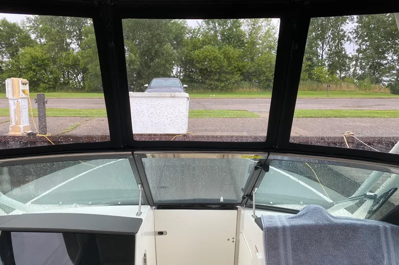 Slide: The Image of Interior view of 2022 Boston Whaler 240 Vantage boat with rain on windows. - 9