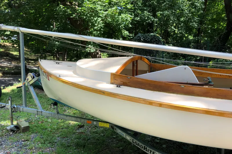 Slide: The Image of 1994 STUR DEE sailboat on trailer, surrounded by lush greenery. - 11