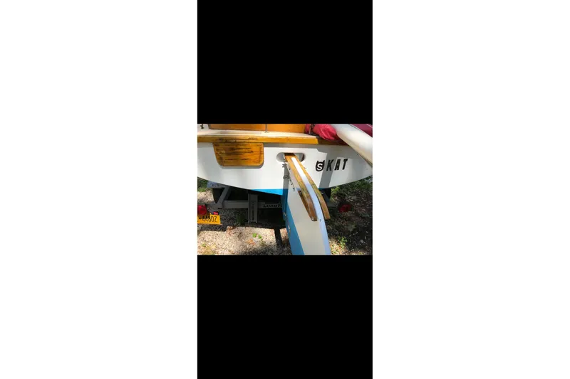 Slide: The Image of 1994 STUR DEE sailboat stern with wooden details and "KAT" lettering. - 12