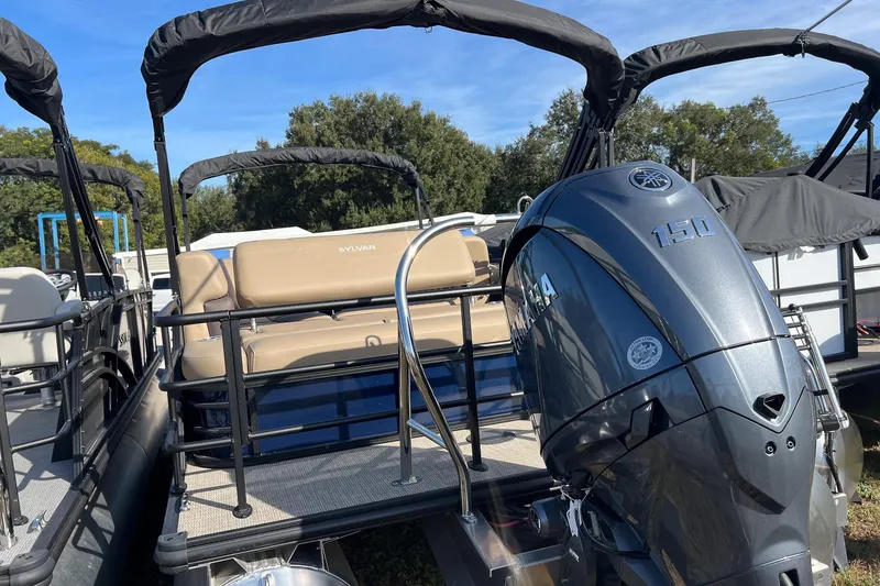 The Image of 2026 Sylvan Mirage 822 CLZ pontoon boat with sleek blue exterior under a clear sky. - 0