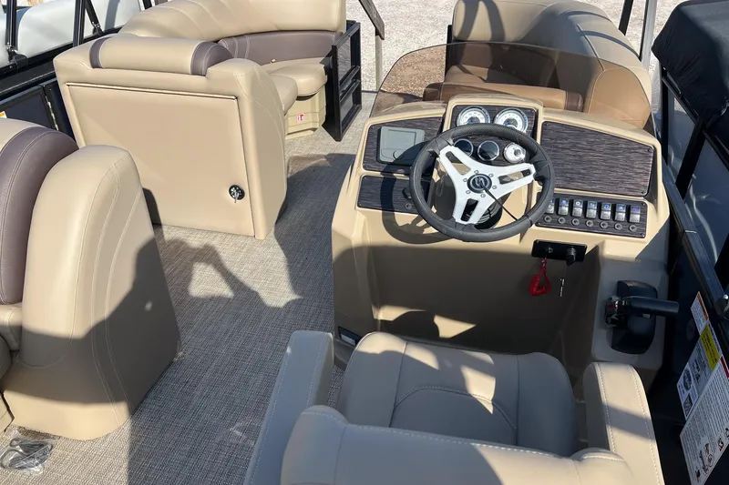 Slide: The Image of 2026 Sylvan Mirage 822 CLZ boat interior with beige seating and modern dashboard. - 11