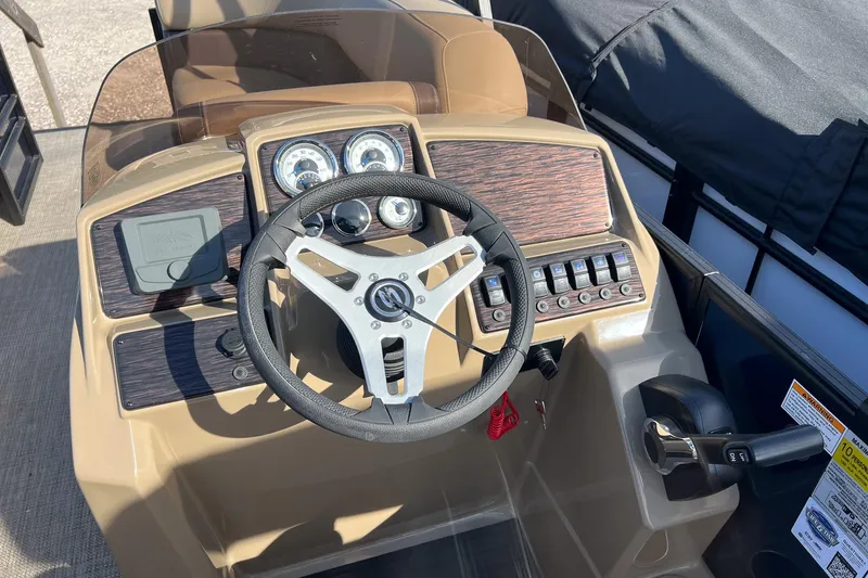 Slide: The Image of 2026 Sylvan Mirage 822 CLZ boat dashboard with steering wheel and control panel. - 12