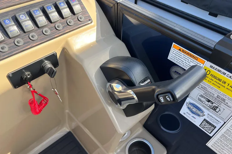 Slide: The Image of Control panel of 2026 Sylvan Mirage 822 CLZ boat with throttle and warning labels. - 15