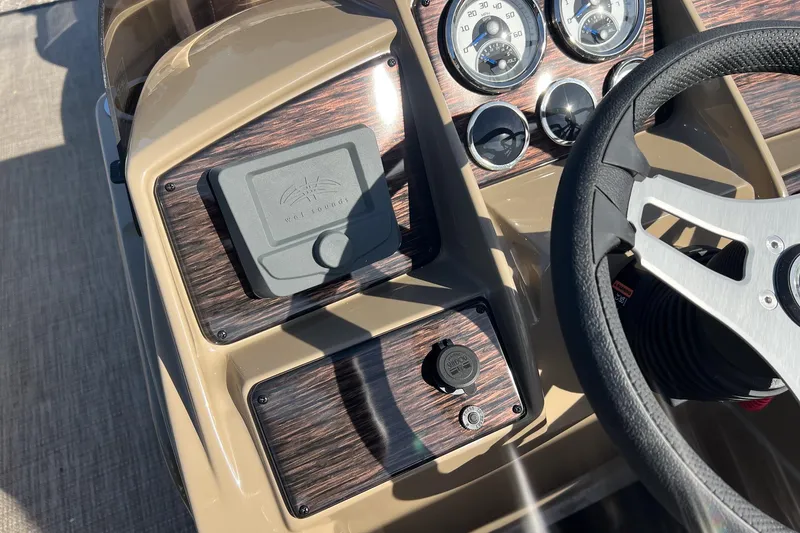 Slide: The Image of Dashboard of 2026 Sylvan Mirage 822 CLZ boat with steering wheel and gauges. - 16