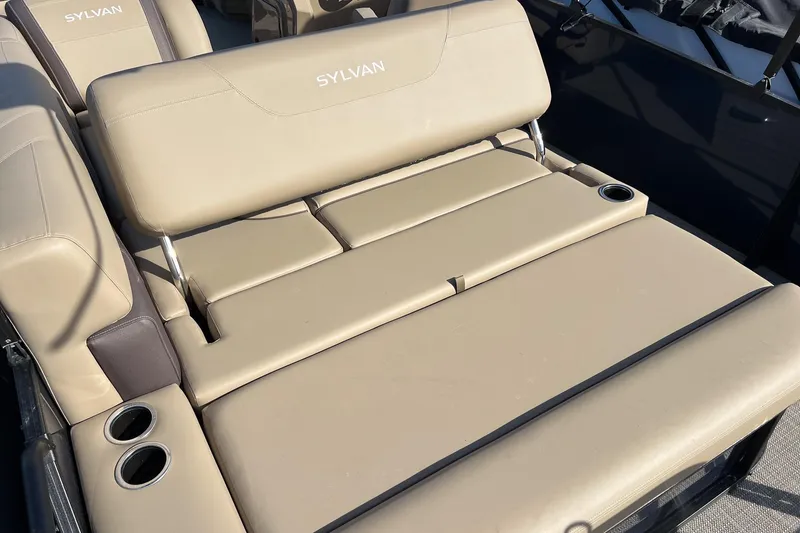 Slide: The Image of 2026 Sylvan Mirage 822 CLZ boat with beige seating and cup holders. - 20