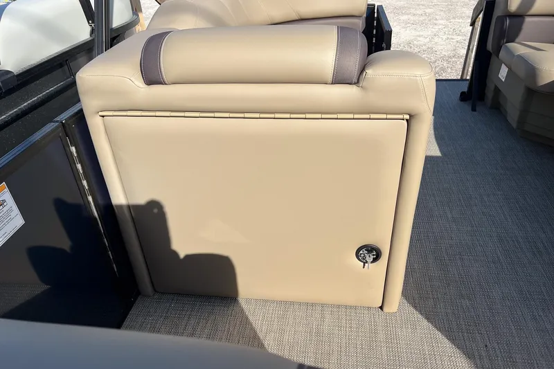 Slide: The Image of 2026 Sylvan Mirage 822 CLZ boat interior with beige seating and storage compartment. - 22