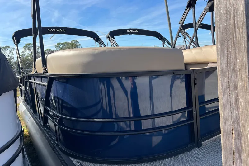 Slide: The Image of 2026 Sylvan Mirage 822 CLZ pontoon boat with beige seating and blue exterior. - 3