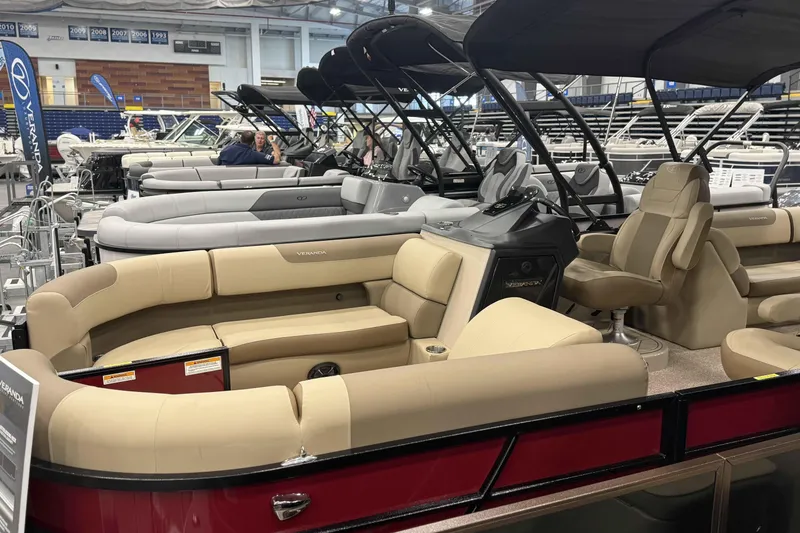 The Image of 2025 Veranda Relax VR 22 RC pontoon boat with beige seating at a boat show. - 0