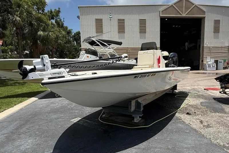 Slide: The Image of 2017 Yellowfin 24 Bay CE boat on display outside a warehouse. - 1