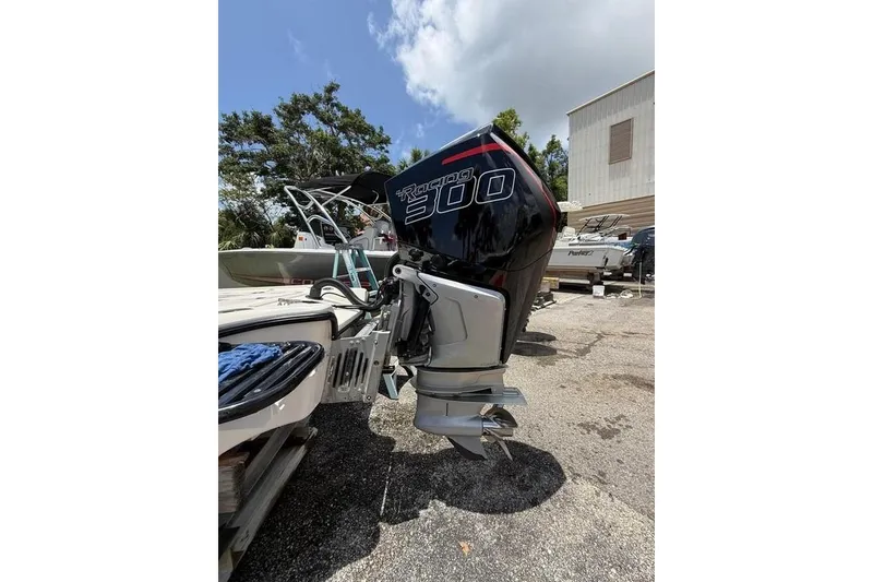 Slide: The Image of 2017 Yellowfin 24 Bay CE with powerful outboard motor in a sunny marina setting. - 11