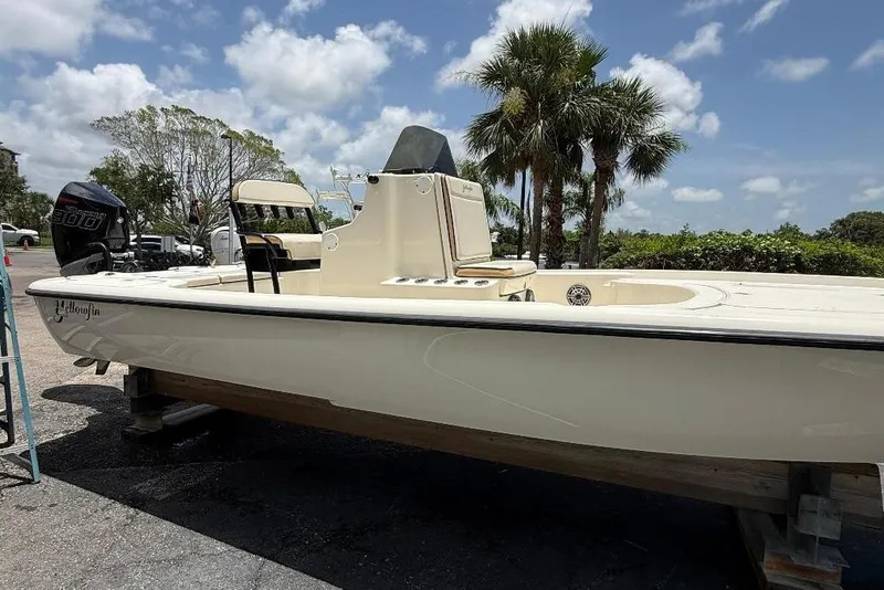 Slide: The Image of 2017 Yellowfin 24 Bay CE boat on display, parked outdoors under a sunny sky. - 2