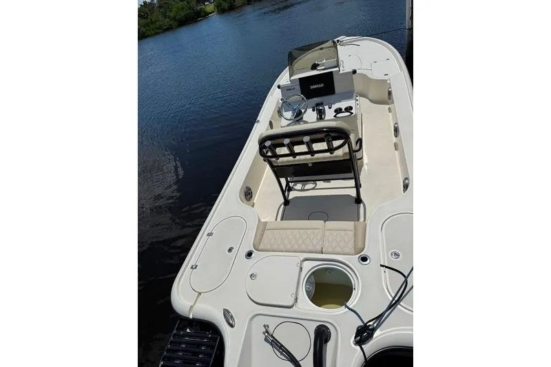 Slide: The Image of 2017 Yellowfin 24 Bay CE boat interior with steering console, seating, and storage compartments. - 22
