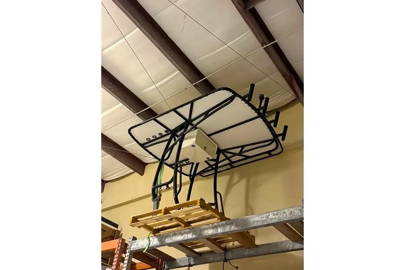 Slide: The Image of 2017 Yellowfin 24 Bay CE boat T-top frame stored on warehouse shelf. - 25