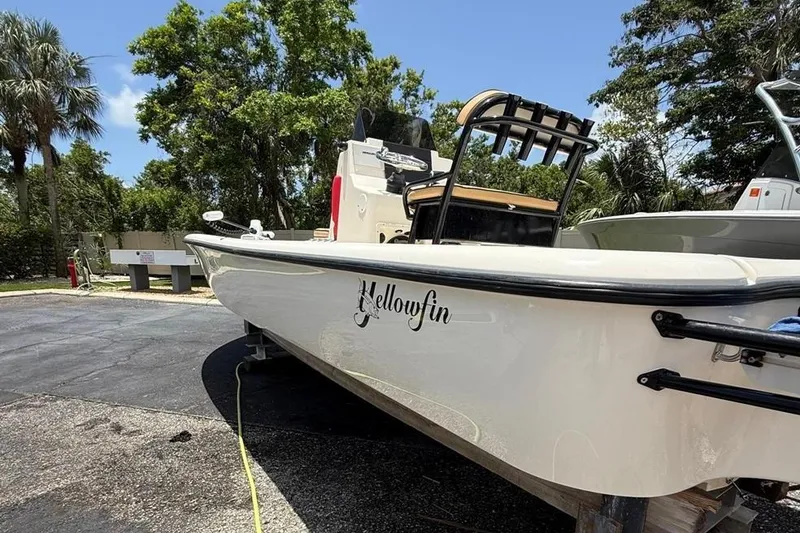 Slide: The Image of 2017 Yellowfin 24 Bay CE boat parked outdoors, surrounded by trees and clear sky. - 3