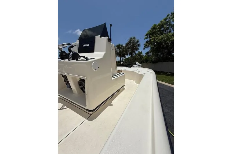 Slide: The Image of 2017 Yellowfin 24 Bay CE boat with Simrad console, sunny day, palm trees in background. - 5