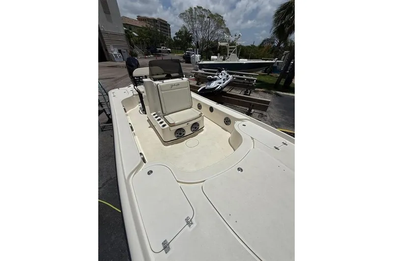Slide: The Image of 2017 Yellowfin 24 Bay CE boat with seating and storage, docked outdoors. - 7