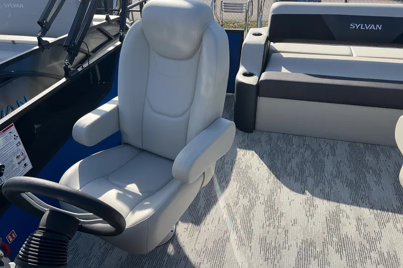 Slide: The Image of 2026 Sylvan R22 LZ DH boat interior with plush seating and steering wheel. - 11