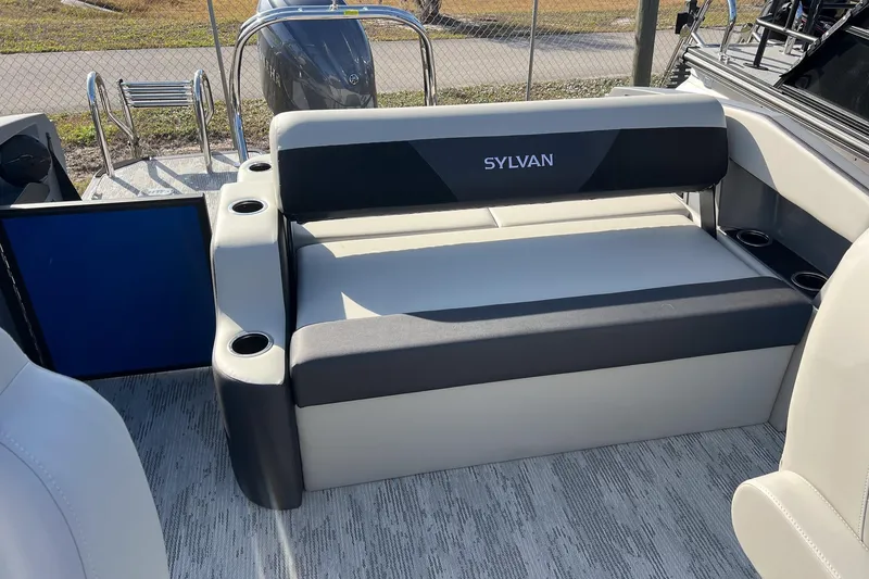 Slide: The Image of 2026 Sylvan R22 LZ DH boat interior with cushioned seating and cup holders. - 15