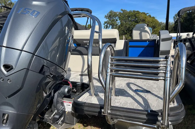 Slide: The Image of 2026 Sylvan R22 LZ DH boat with powerful 150 engine and sleek ladder design. - 2