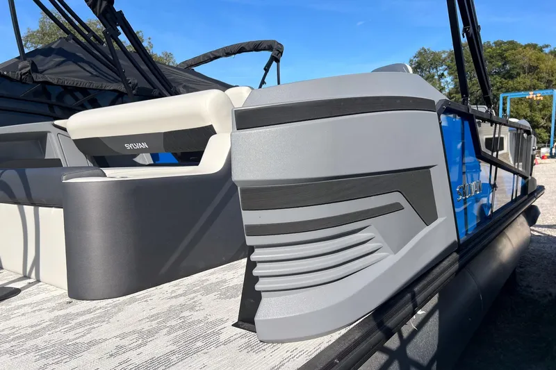 Slide: The Image of 2026 Sylvan R22 LZ DH pontoon boat, sleek design, gray and blue accents, outdoor setting. - 4