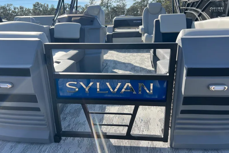 Slide: The Image of 2026 Sylvan R22 LZ DH pontoon boat interior with seating and Sylvan logo. - 5