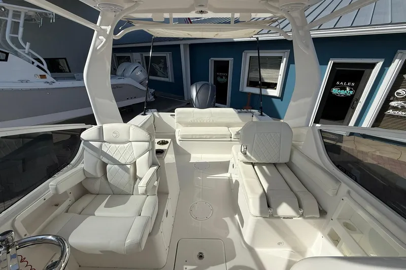 Slide: The Image of 2019 Edgewater 230CX Crossover boat interior with white seating and modern design. - 15