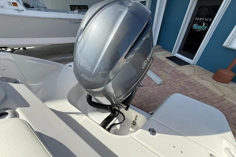 Slide: The Image of 2019 Edgewater 230CX Crossover boat with Yamaha outboard motor, docked near service area. - 5